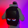 A person wearing a backpack with a customizable LED screen on the back, controlled via a smartphone app.
