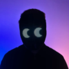 Person with an illuminated LED mask displaying a digital pattern, standing in front of a neon pink and blue background.