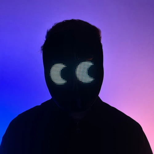 Person with an illuminated LED mask displaying a digital pattern, standing in front of a neon pink and blue background.
