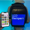 A person wearing a backpack with a customizable LED screen on the back, controlled via a smartphone app.